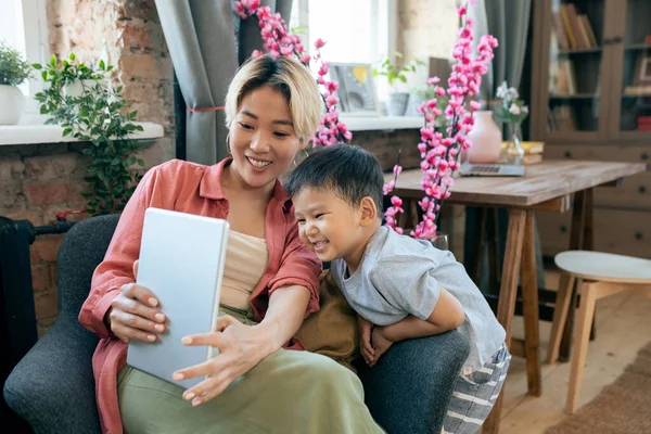 Happy cute little boy and his mother communicating in video chat — Stock Photo, Image