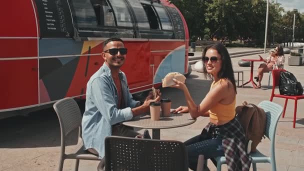 Medium Portrait Young Cheerful Couple Sunglasses Tacos Hands Sitting Table — 图库视频影像