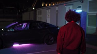 Gece şarj istasyonunda elektrikli arabanın fişini çekerken tanınmayan kadın sürücünün arka camını izliyorum. Trafo kutusunun kapısında voltaj bilgisi ve kelime bölümü yazılı