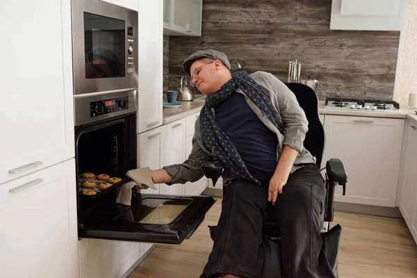 Contemporary man with disability baking cookies — Stock Photo, Image