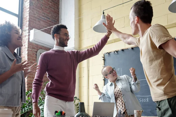 Two young successful businessmen giving each other high five — Fotografia de Stock