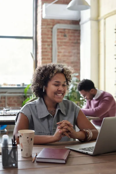 Happy young businesswoman with earphones watching online video — Fotografia de Stock