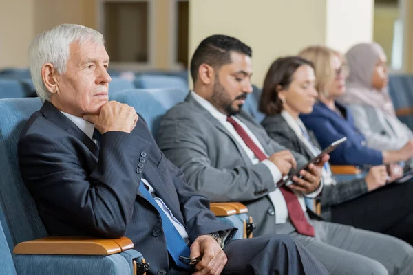 Senior zakenman of politicus in formele kleding luisteren naar spreker — Stockfoto