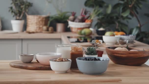 Close Tracking Shot Milk Honey Jars Berries Fruit Nuts Bowls — Vídeo de Stock