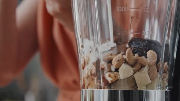 Extreme Close Pan Unrecognizable Woman Pouring Milk Blender Cashews Figs — Stock Video