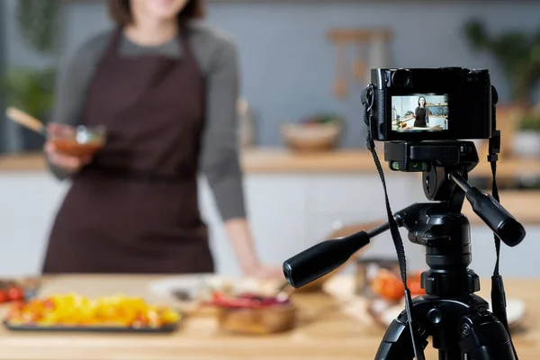 Young female blogger giving cooking masterclass in front of video camera — Stock Photo, Image