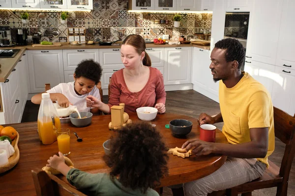 Współczesna międzyrasowa rodzina je śniadanie przy stole — Zdjęcie stockowe