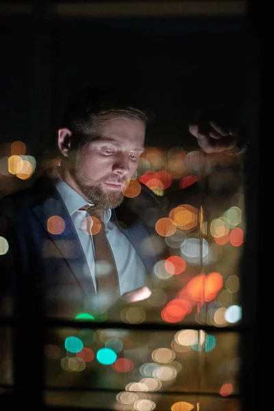 Contemporary businessman looking through contacts in mobile phone — Stock Photo, Image