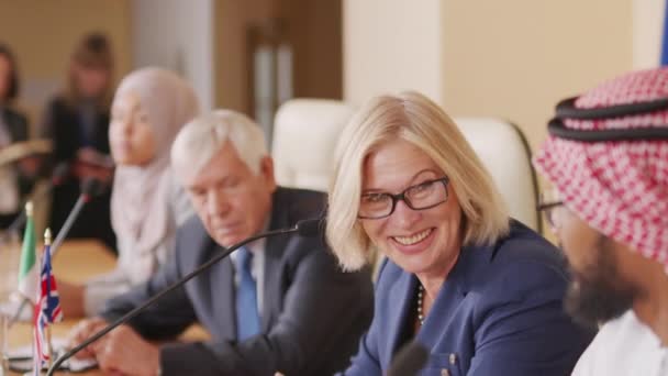 Yüzünde Gözlüklerle Gülümseyen Beyaz Kadın Politikacının Kapalı Alandaki Basın Toplantısında — Stok video