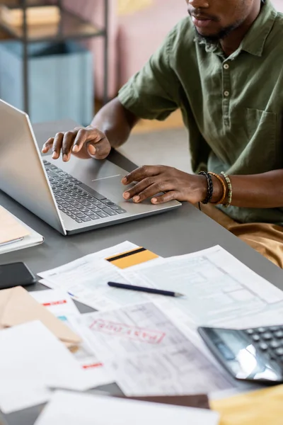 Hands of young African male economist working in front of laptop — Stock fotografie