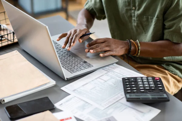 Hands of young African man typing on laptop keypad — 图库照片