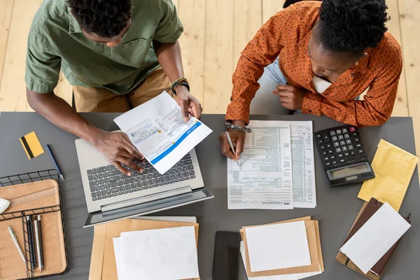 Overview of two young economists discussing financial papers — Stock fotografie