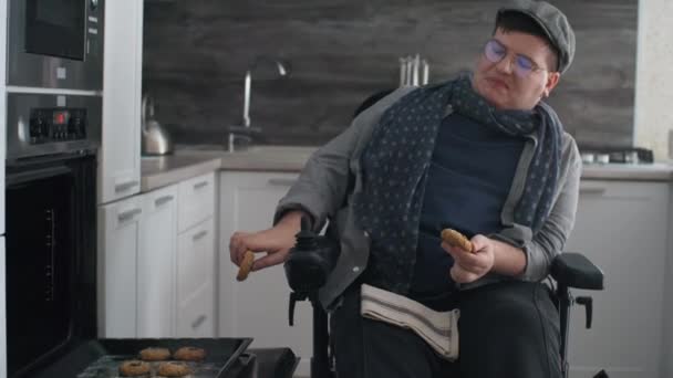 Locked Caucasian Man Wheelchair Wearing Eyeglasses Peaked Cap Taking Cookies — Stockvideo