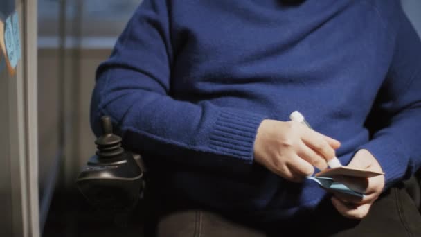 Tilting Young Caucasian Man Wheelchair Wearing Blue Long Sleeve Writing — Stockvideo