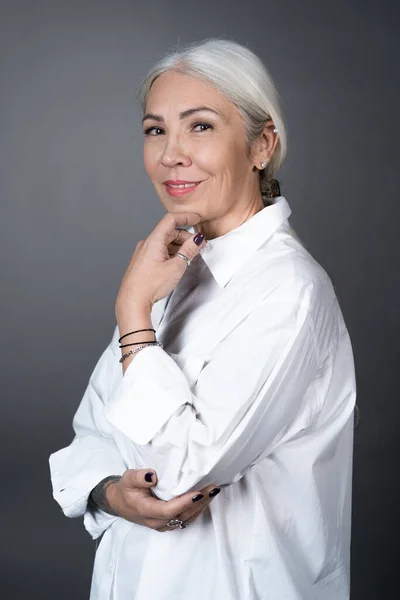 Beautiful senior woman in white blouse — Stock Photo, Image