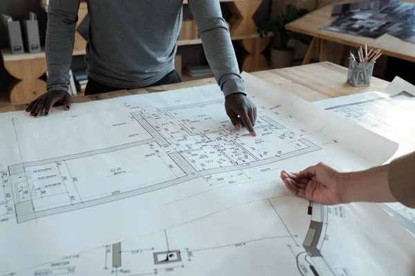 Mains de deux jeunes ingénieurs discutant des détails du croquis — Photo