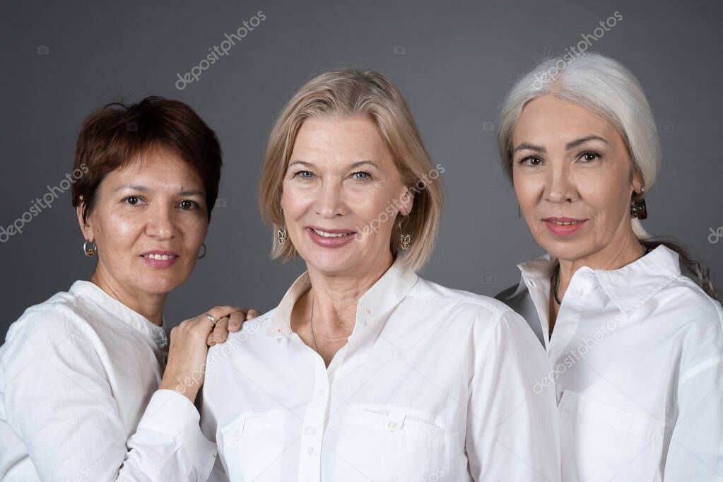 Portrait of mature women in white shirts