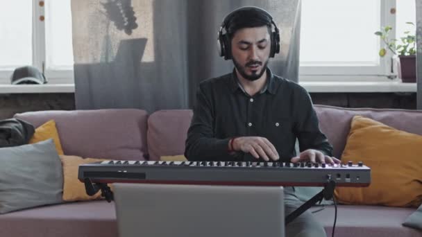 Medium Long Young Asian Man Wearing Beard Earphones Sitting Couch — Stock Video