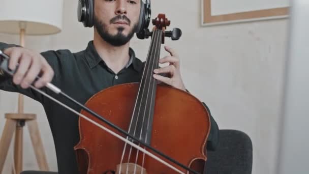 Tilting Young Asian Man Wearing Ear Headphones Beard Sitting Armchair — Stock Video