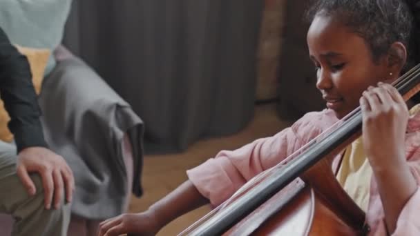 Tilting Happy Black Ten Year Old Girl Sitting Home Afternoon — Stock Video