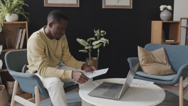 Medium Long Young Black Man Sitting Armchair Home Daytime Teaching — Stock Video