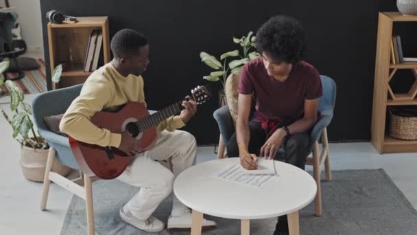 Full Shot Curly Haired Young Man Sitting Armchair Living Room — Stock Video