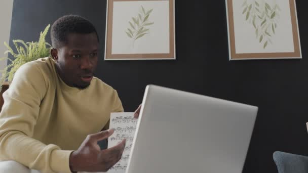 Low Angle Young Black Man Sitting Armchair Home Daytime Teaching — Stock Video