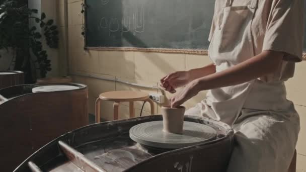 Titling Young Caucasian Woman Wearing Apron Sitting Pottery Wheel Making — Stock Video
