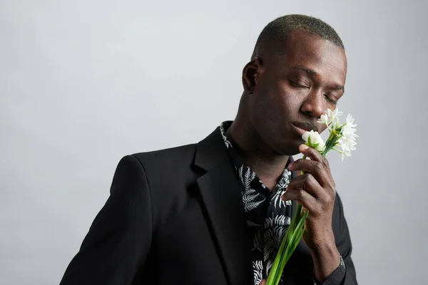 African man enjoying the beautiful flower — Stock Photo, Image