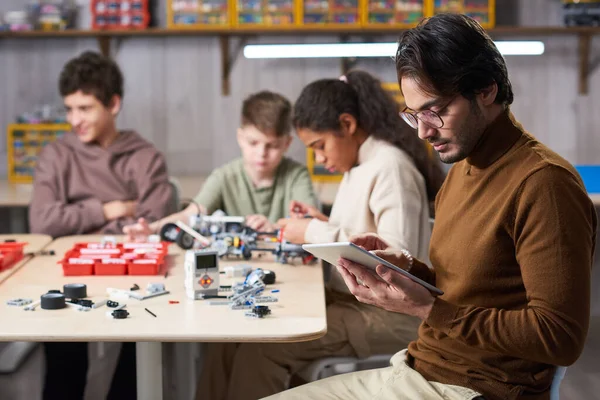 Jonge mannelijke leraar in robotica klasse — Stockfoto