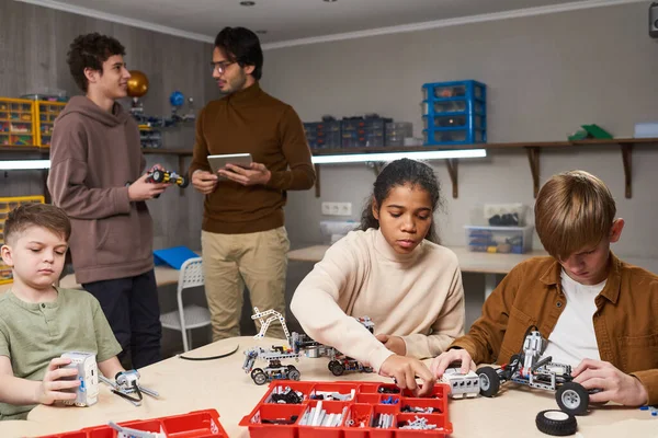 Grupo de adolescentes proyectando robots en la lección de ciencias —  Fotos de Stock