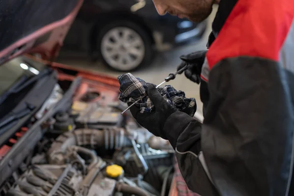 Gloved mechanic in workwear preparing handtool for repairing car — Stock Photo, Image