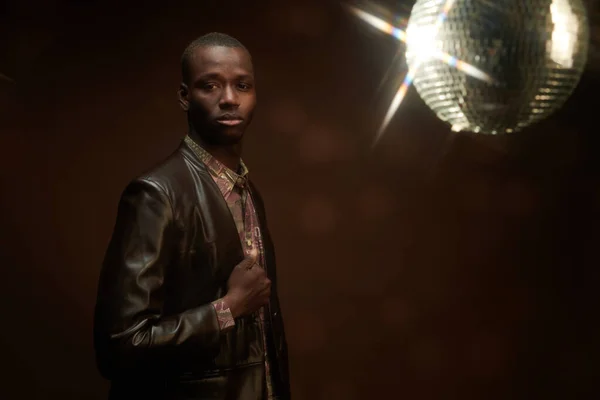 Young serious man of African ethnicity in shirt and leather jacket — Stock Photo, Image