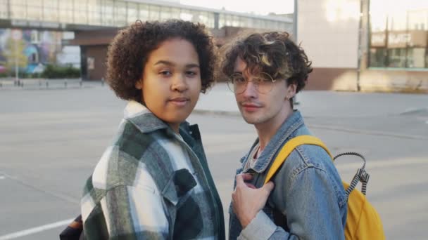 年轻的白种人男人戴着眼镜和非洲裔美国女性朋友的胸部 夏天站在城外拍照 在镜头前看着和微笑 — 图库视频影像