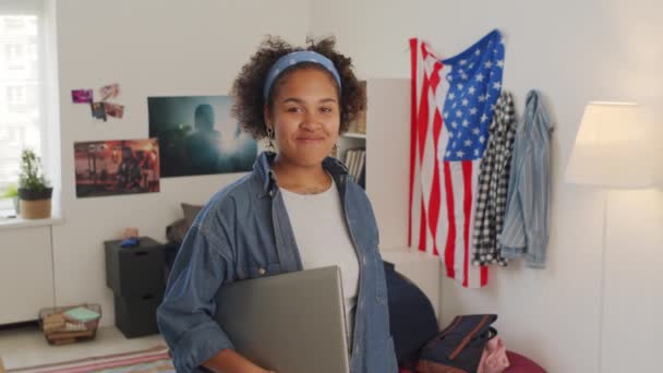 Medium Portrait Black Female Student Holding Portable Computer Standing Bedroom — стоковое видео