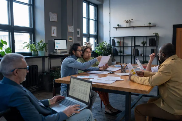 Group of intercultural economists discussing financial papers — Stock Photo, Image