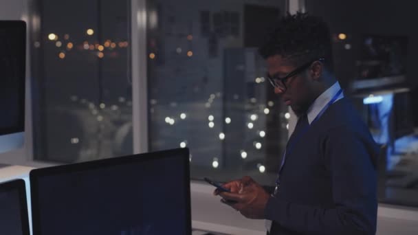 아프리카 미국인 전문가 스마트폰을 사용하여 사무실에 컴퓨터 코드를 실행하는 프로그램을 — 비디오