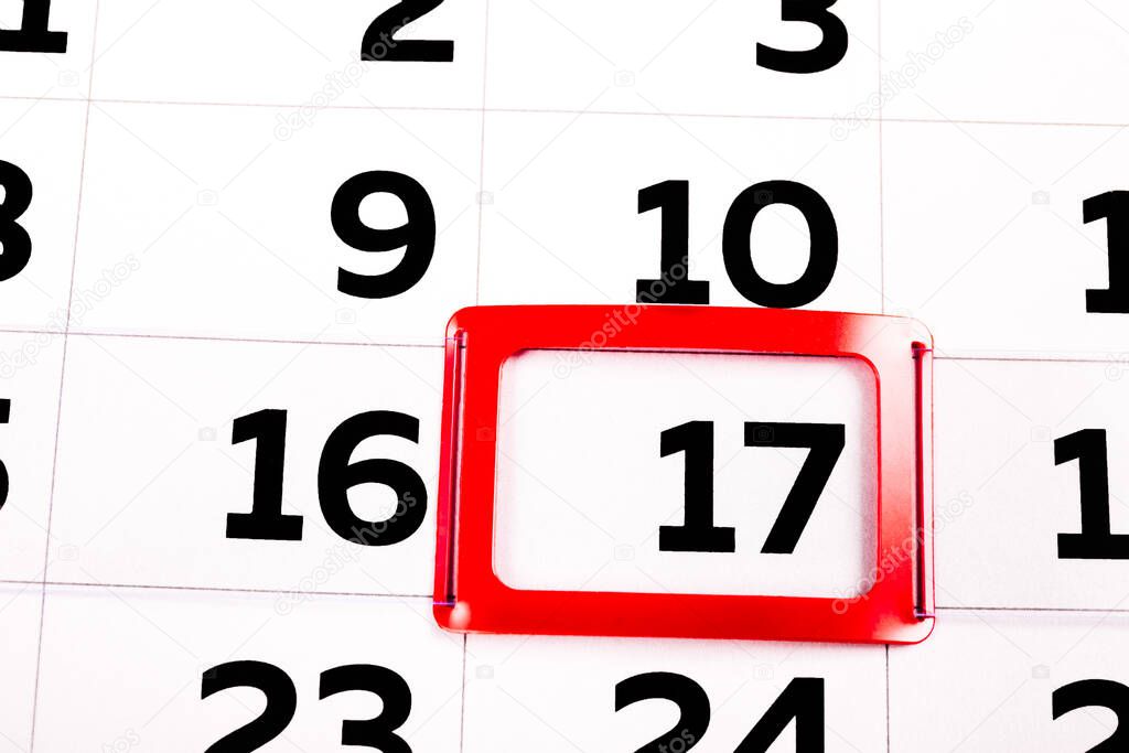 White paper calendar sheet with the black number seventeen marked in a red rectangle frame. Feast day or icon of holiday. Close-up of today. Schedule of events and agenda. Business time management.