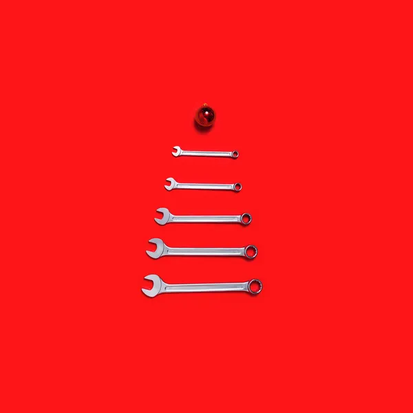圣诞树是用红色背景的球装饰的扳手做成的 有工具的新年横幅 明信片上印有工业节日的概念 为快乐的新年祝福文字 后续行动 — 图库照片