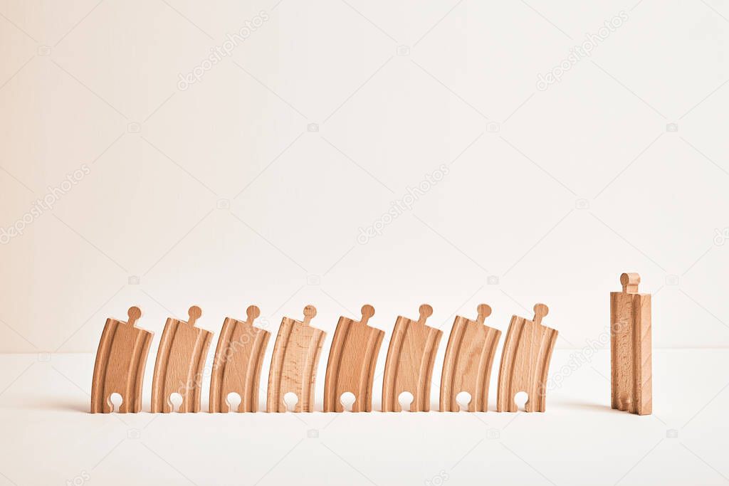 Religious concept. Kindergarten group. Adult and children. Business coach and team. President and people. Mentor and followers. Orator and listeners. Teacher with students. Wooden railway toy element.