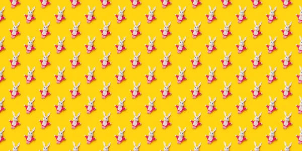 Seamless pattern. Easter bunnies isolated on yellow background. Funny texture. Education toy theater online course. Hand puppet. Sewing hobby. Fairy tale character. Fluffy baby play friend. Wallpaper — Stock Photo, Image
