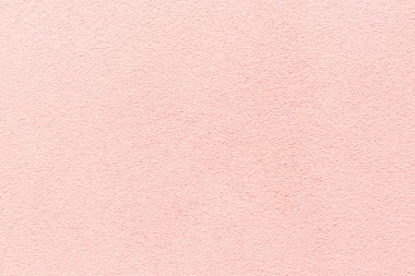 Pembe alçı dokusu örneği. Duvar, dekoratif çimento sıva ile kaplanmış. Dış bina dekorasyonu örneğiydi. Temiz üniformalı, kumlu bir geçmişi var. Pankart. Duvar kağıdı. Uzayı kopyala Desen.