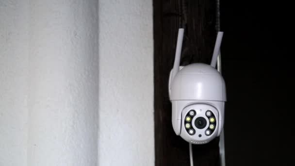 Cámara CCTV blanca con antenas gira y graba objetos en movimiento. Sistema de seguridad de propiedad privada. Videovigilancia exterior. Filmación. Copiar espacio. Cámara Web. Control de calles. Reloj de distancia. Inteligente — Vídeos de Stock