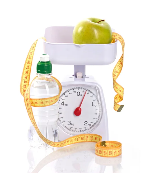 Weight-scales, measure, apple and bottle with aqua — Stock Photo, Image
