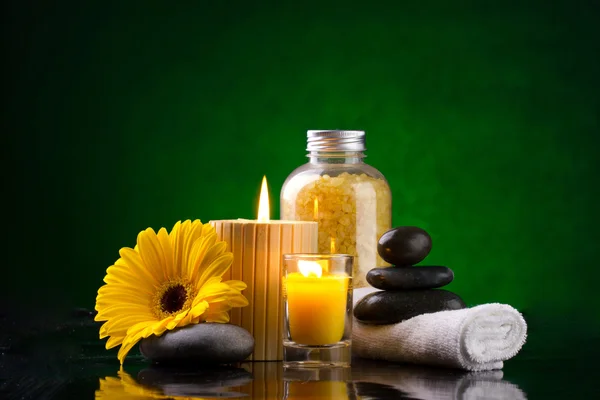 Spa still life with sea salts candles flower towel and stones — Stock Photo, Image