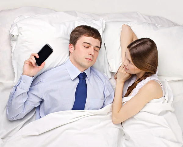 Woman and businessman in bed — Stock Photo, Image