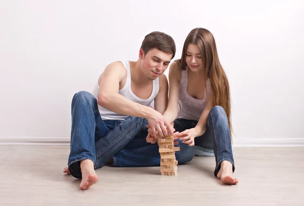 Guy and girl building of tower — Stock Photo, Image