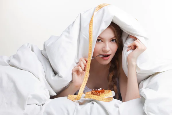 Young woman eating spoon — Stock Photo, Image