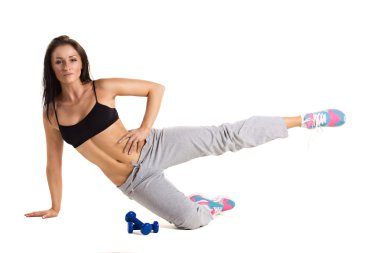 young sportive woman training with dumbbels clipart