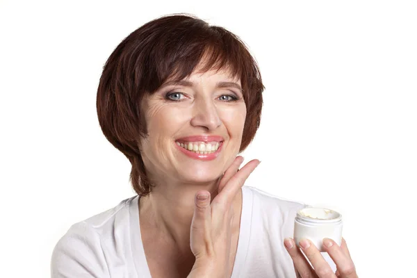 Mature woman with facial cream — Stock Photo, Image